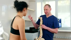 Stock Video A Doctor Shows A Spine To An Athlete Live Wallpaper for PC