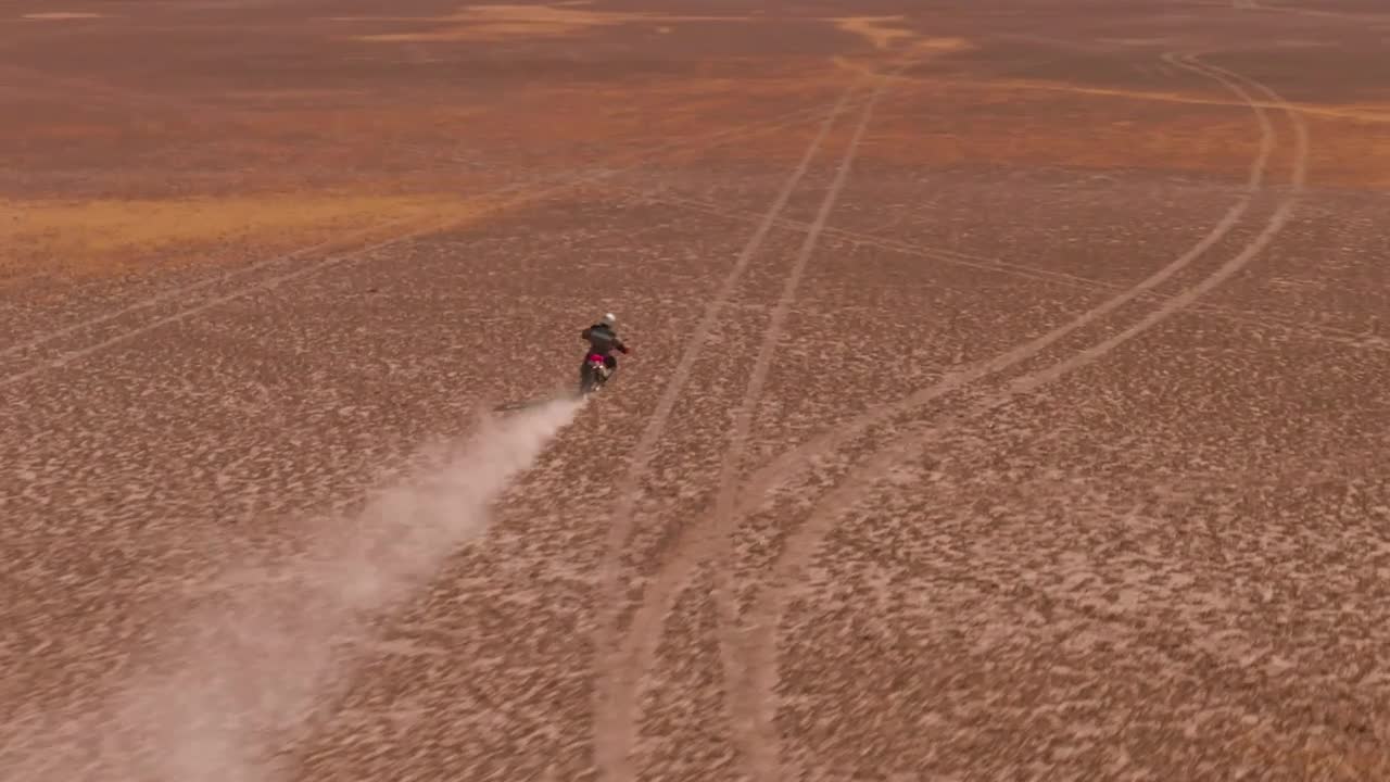 Download Stock Video Aerial Shot Of A Motorcyclist In The Desert Live Wallpaper for PC