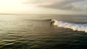 Stock Video Aerial Tracking Shot Of A Man Surfing On The Ocean Live Wallpaper for PC