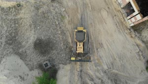 Stock Video Aerial View Of A Bulldozer On A Dirt Field Live Wallpaper for PC
