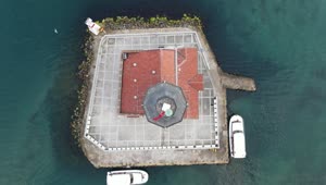 Stock Video Aerial View Of A Lighthouse On A Small Island Live Wallpaper for PC