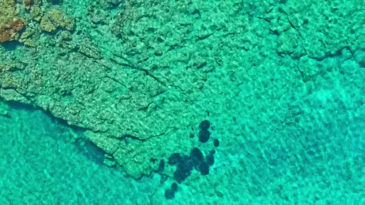 Download Stock Video Aerial View Of Crystal Clear Rocky Sea Shore Live Wallpaper for PC
