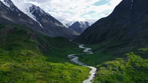 Stock Video Aerial View Of Lush River Valley And Snowy Mountains Live Wallpaper for PC