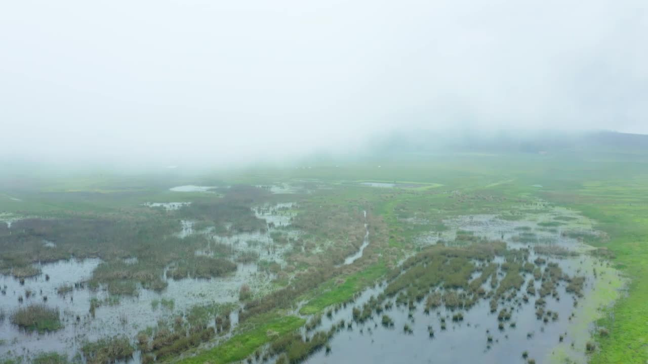 Download Stock Video Aerial View Over A Cloudy Meadow Covered With Water Live Wallpaper for PC