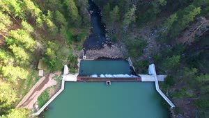 Stock Video Aerial View Over A Dam Between A Pine Forest Live Wallpaper for PC