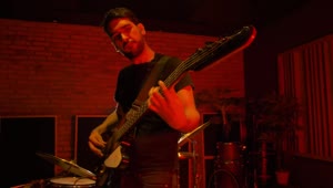 Stock Video Bass Player Playing On A Red Lit Spot Live Wallpaper For PC