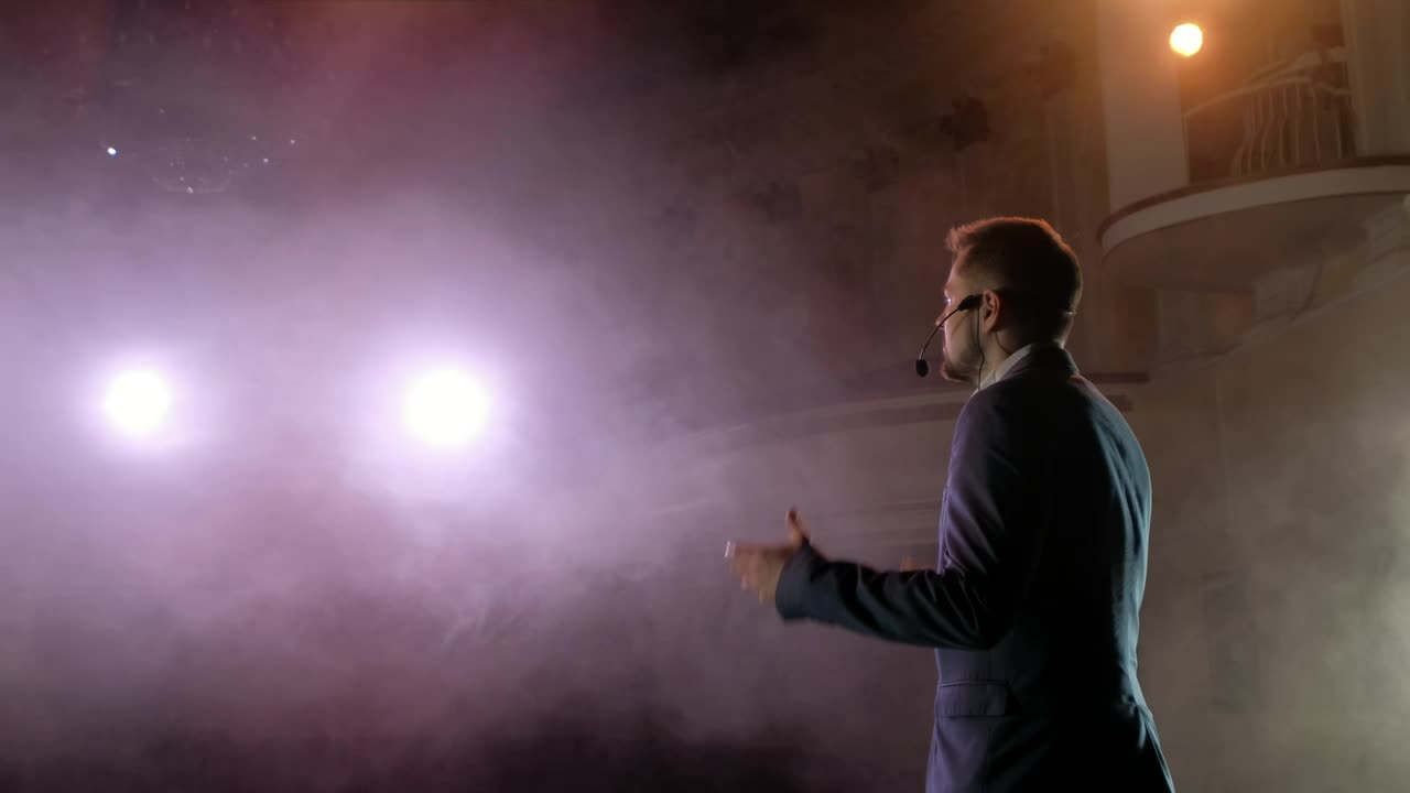 Download Stock Video Back View Of A Showman Giving A Talk Live Wallpaper For PC