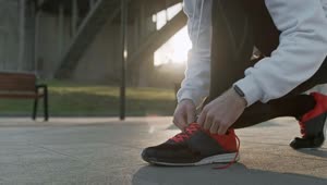 Stock Video Athlete Tying Shoelaces Before Training Live Wallpaper For PC
