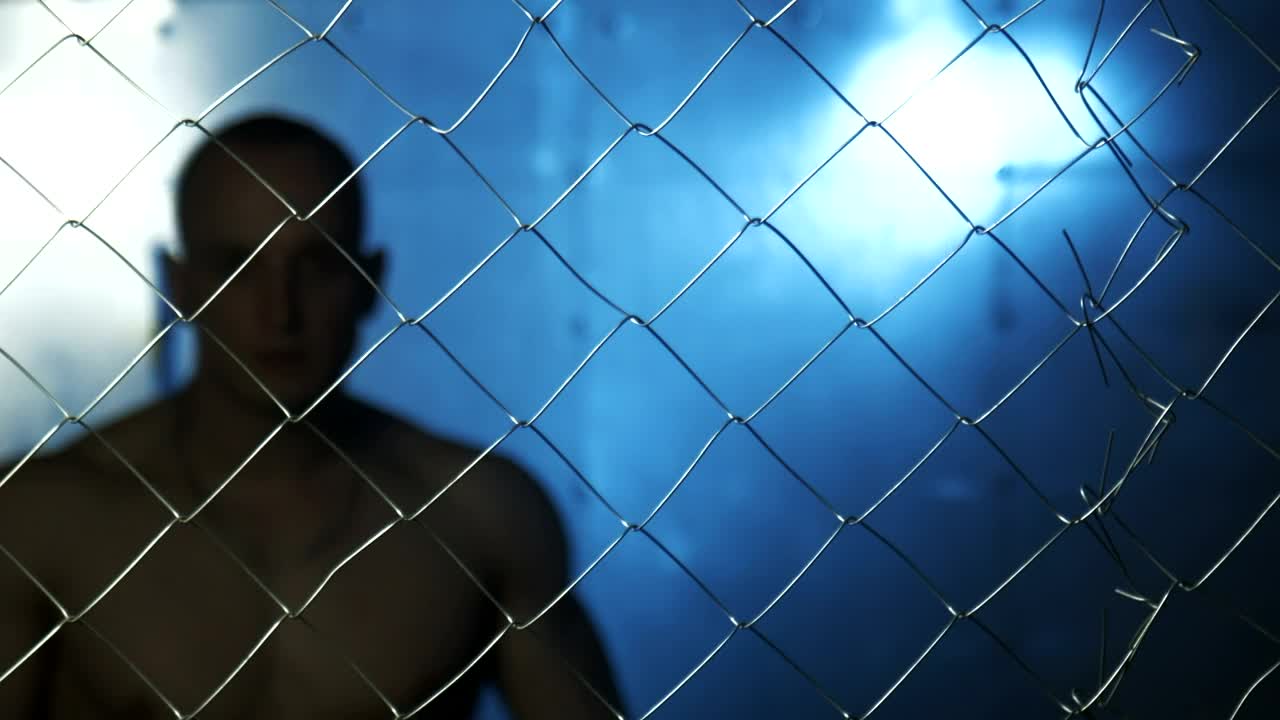 Download Stock Video Angry Shirtless Man Behind Wire Fence Live Wallpaper For PC