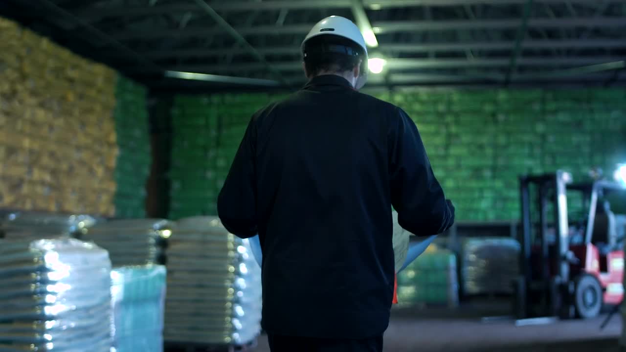Download Stock Video An Engineer With Blueprint Walking On A Warehouse Live Wallpaper For PC