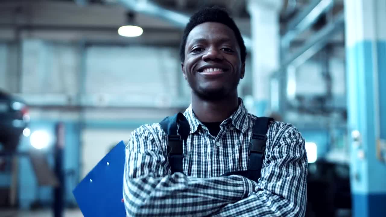 Download Stock Video A Young Mechanic Is Smiling To The Camera Live Wallpaper For PC