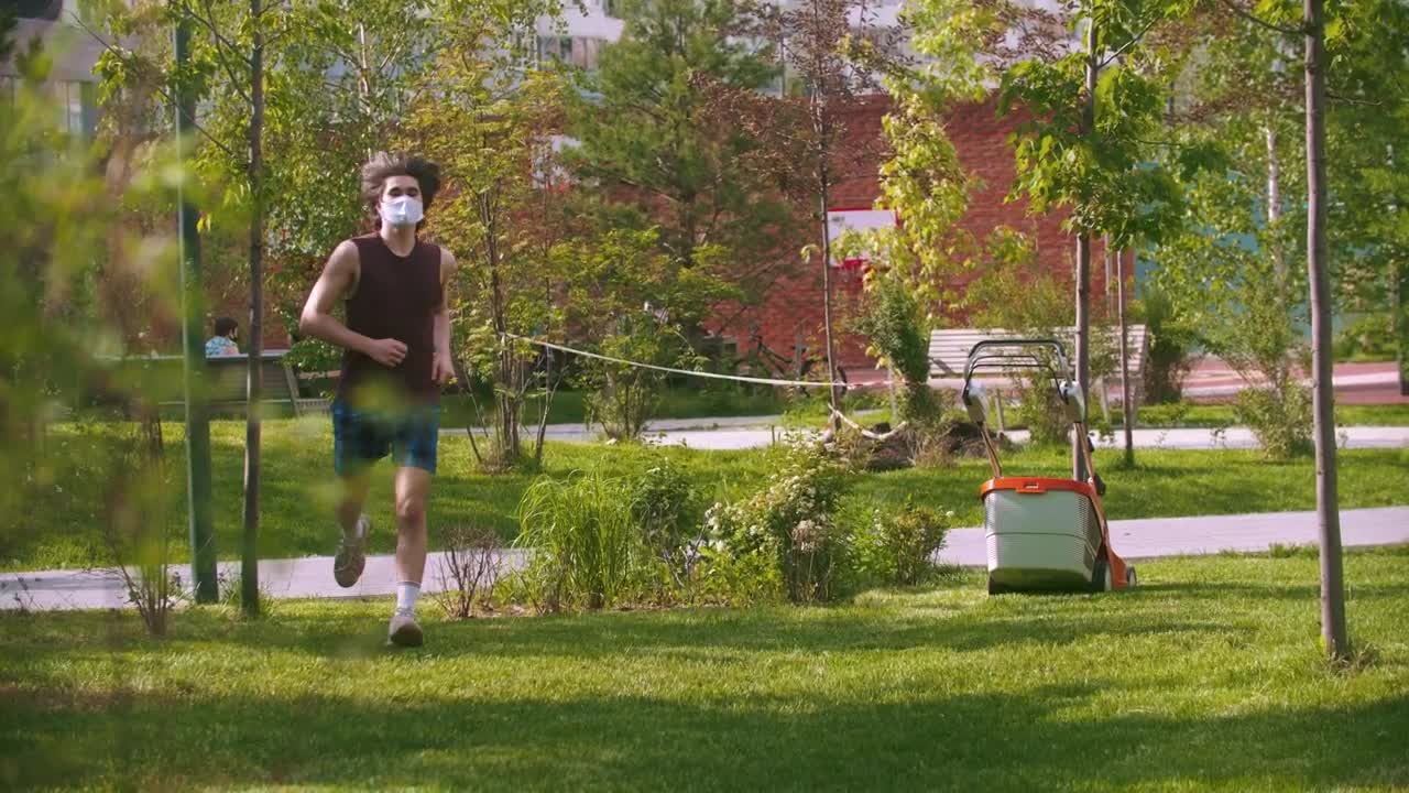 Download Stock Video A Young Man With A Medical Mask Exercising In The Live Wallpaper For PC