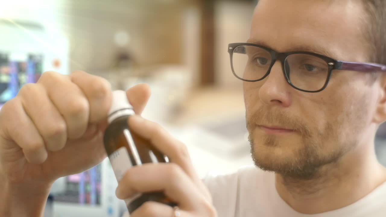 Download Stock Video A Young Man With Glasses Taking Medicine In The Hospital Live Wallpaper For PC