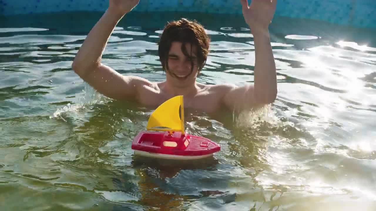 Download Stock Video A Young Man In The Pool With A Toy Boat Live Wallpaper For PC
