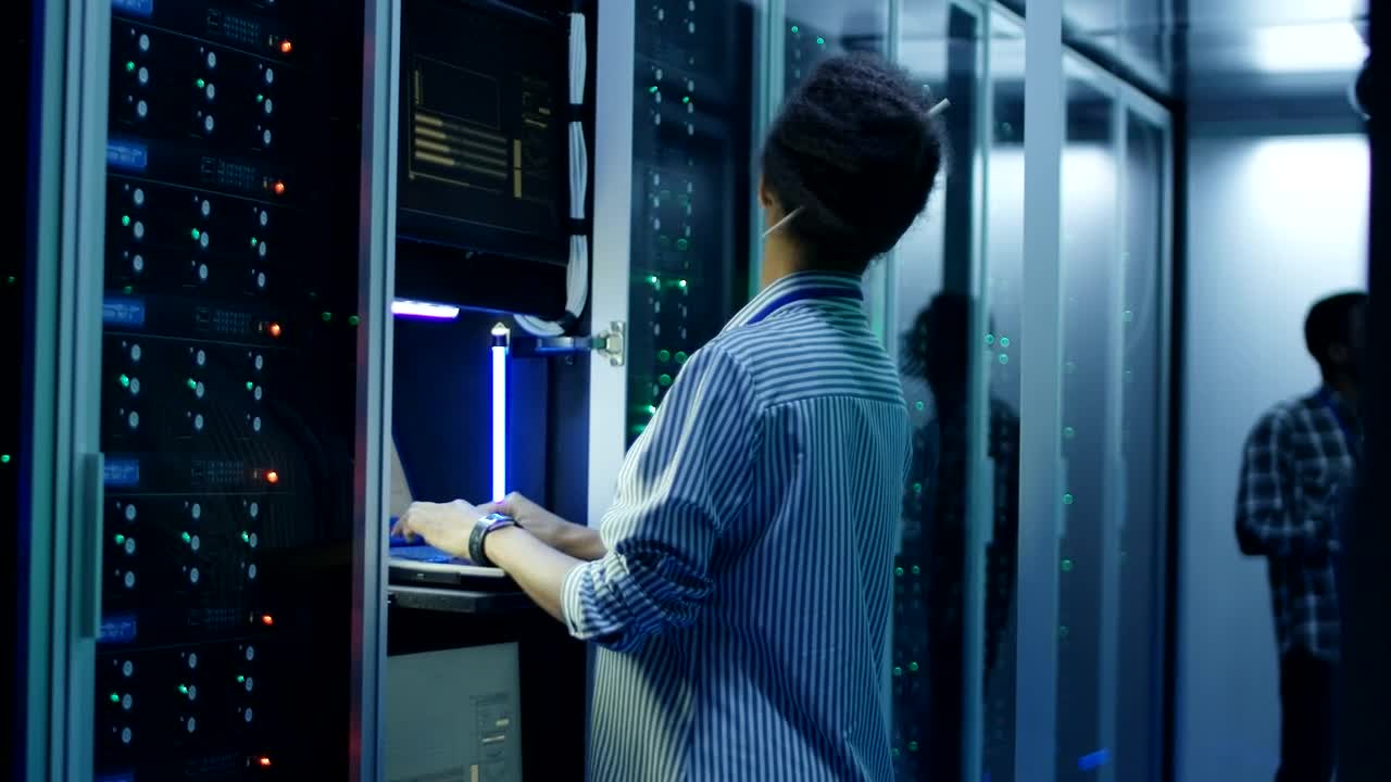 Download Stock Video A Woman Working With A Computer In The Server Room Live Wallpaper For PC