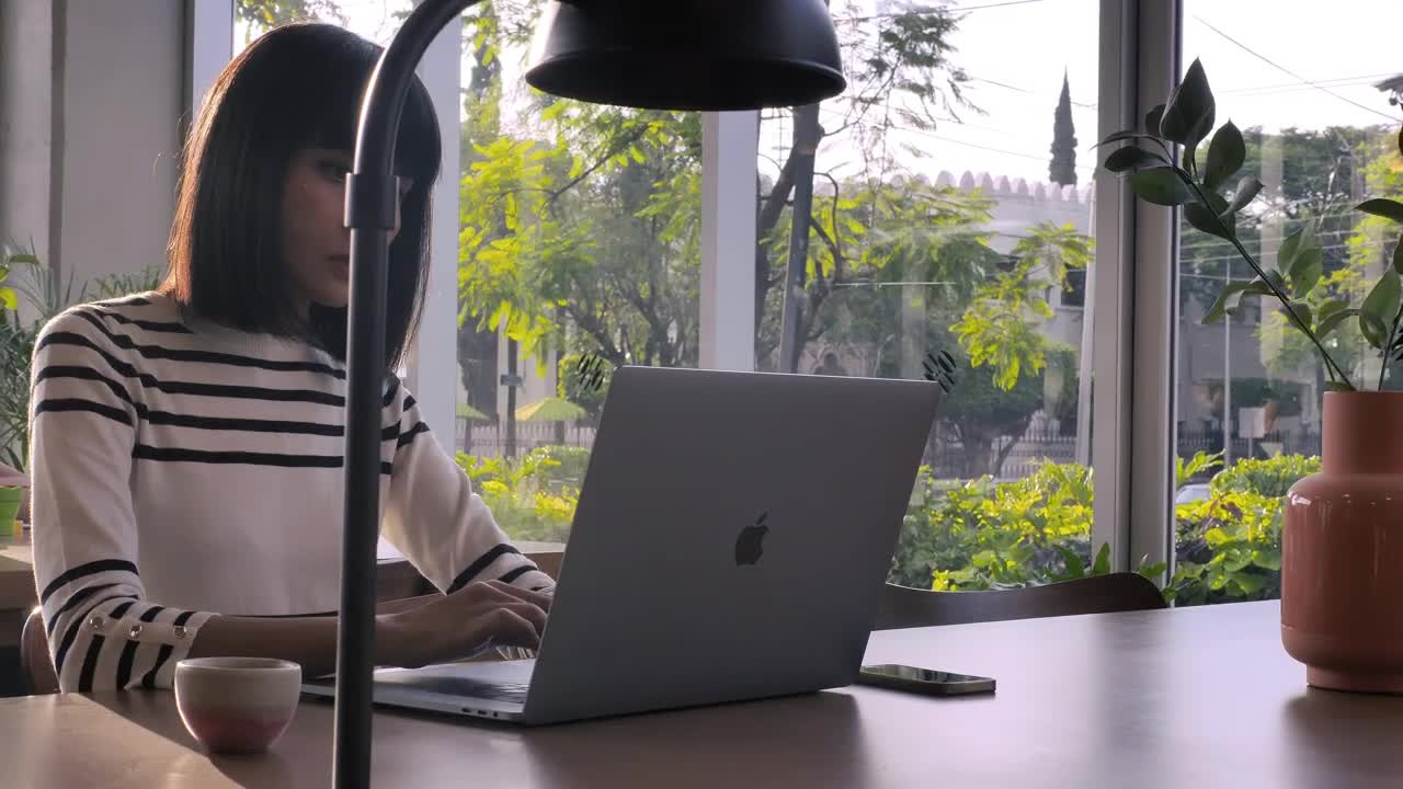 Download Stock Video A Woman Working On Her Laptop At An Office Live Wallpaper For PC