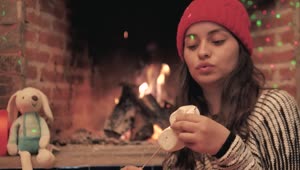 Stock Video A Woman Warms Marshmallows In The Fire Of Her Fireplace Live Wallpaper For PC