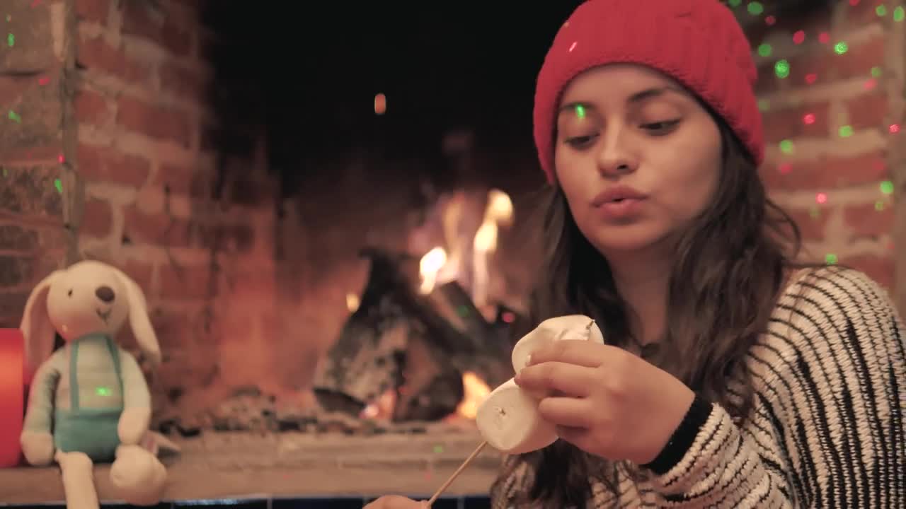 Download Stock Video A Woman Warms Marshmallows In The Fire Of Her Fireplace Live Wallpaper For PC