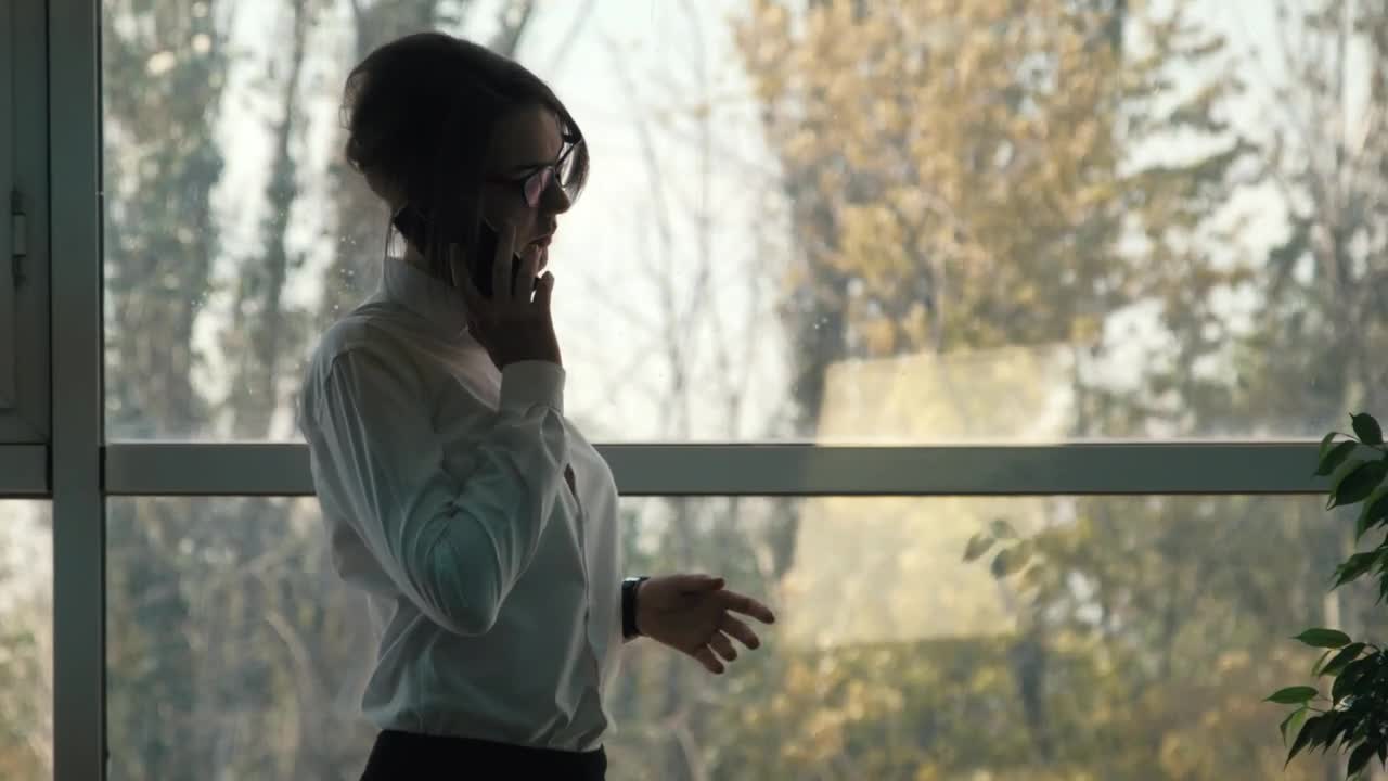 Download Stock Video A Woman Talking On The Phone Near The Window Live Wallpaper For PC