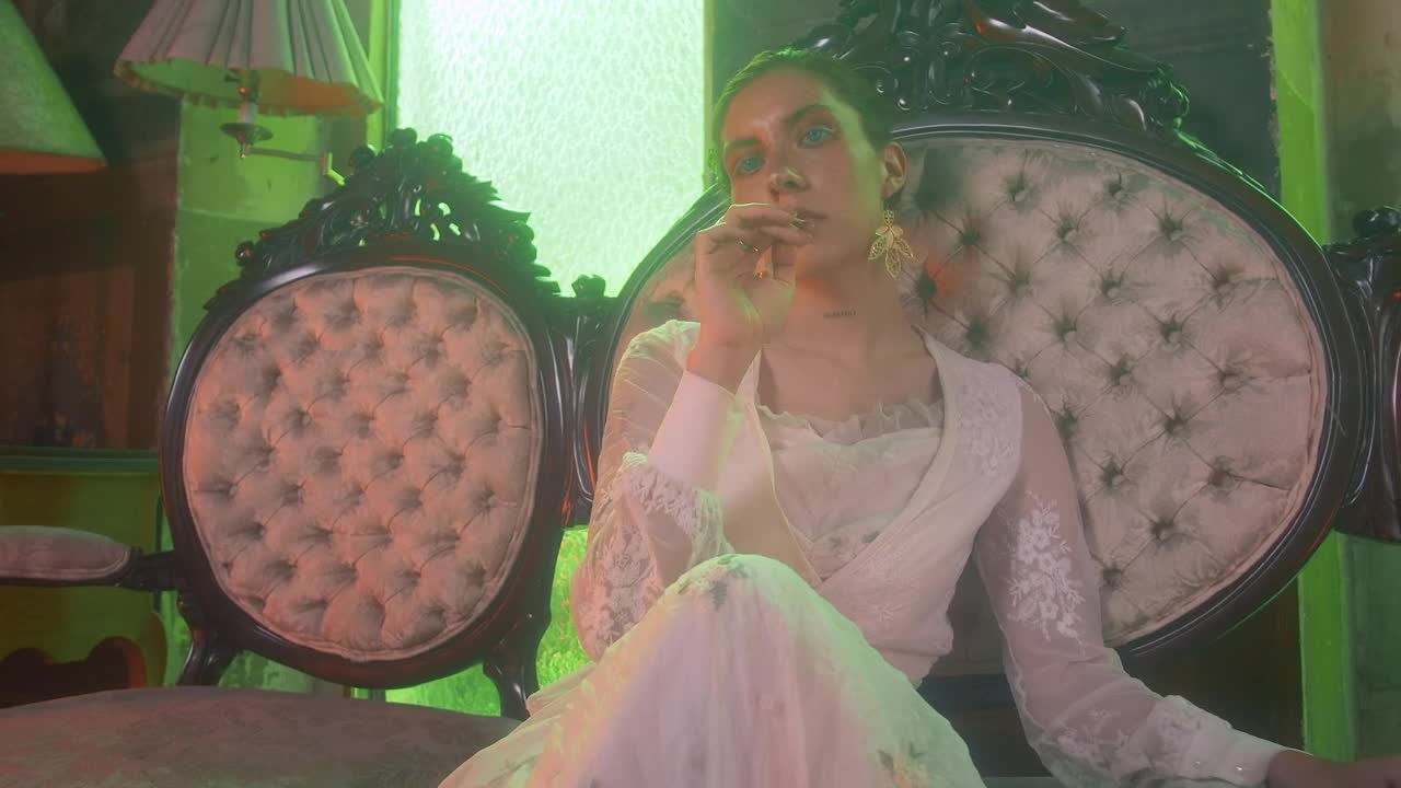 Download Stock Video A Woman Sitting In A Vintage Couch Looks Into The Live Wallpaper For PC