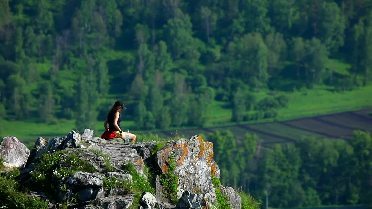 Download Stock Video A Woman Sitting At The Top Of The Mountain Live Wallpaper For PC