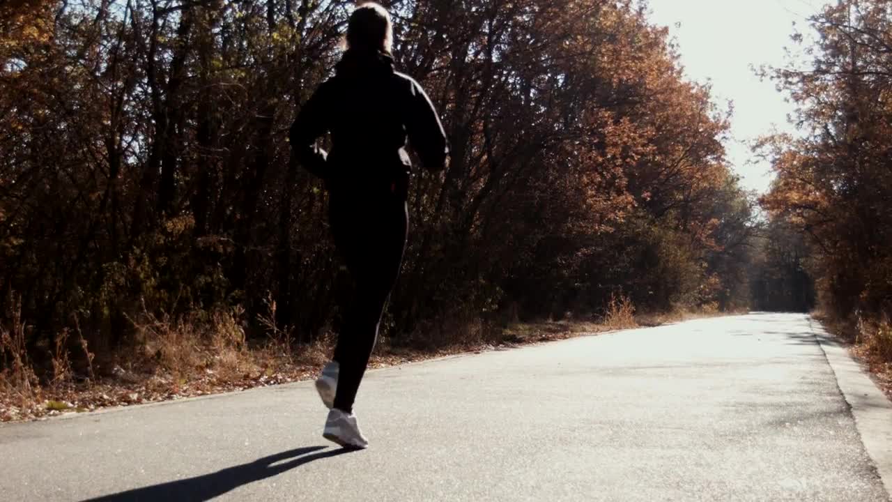 Download Stock Video A Woman Running On A Path In Autumn Live Wallpaper For PC