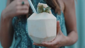 Stock Video A Woman Drinking Coconut Water With A Straw Live Wallpaper For PC