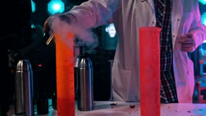 Stock Video A Scientist Pours The Liquid Nitrogen Into Flasks Live Wallpaper For PC