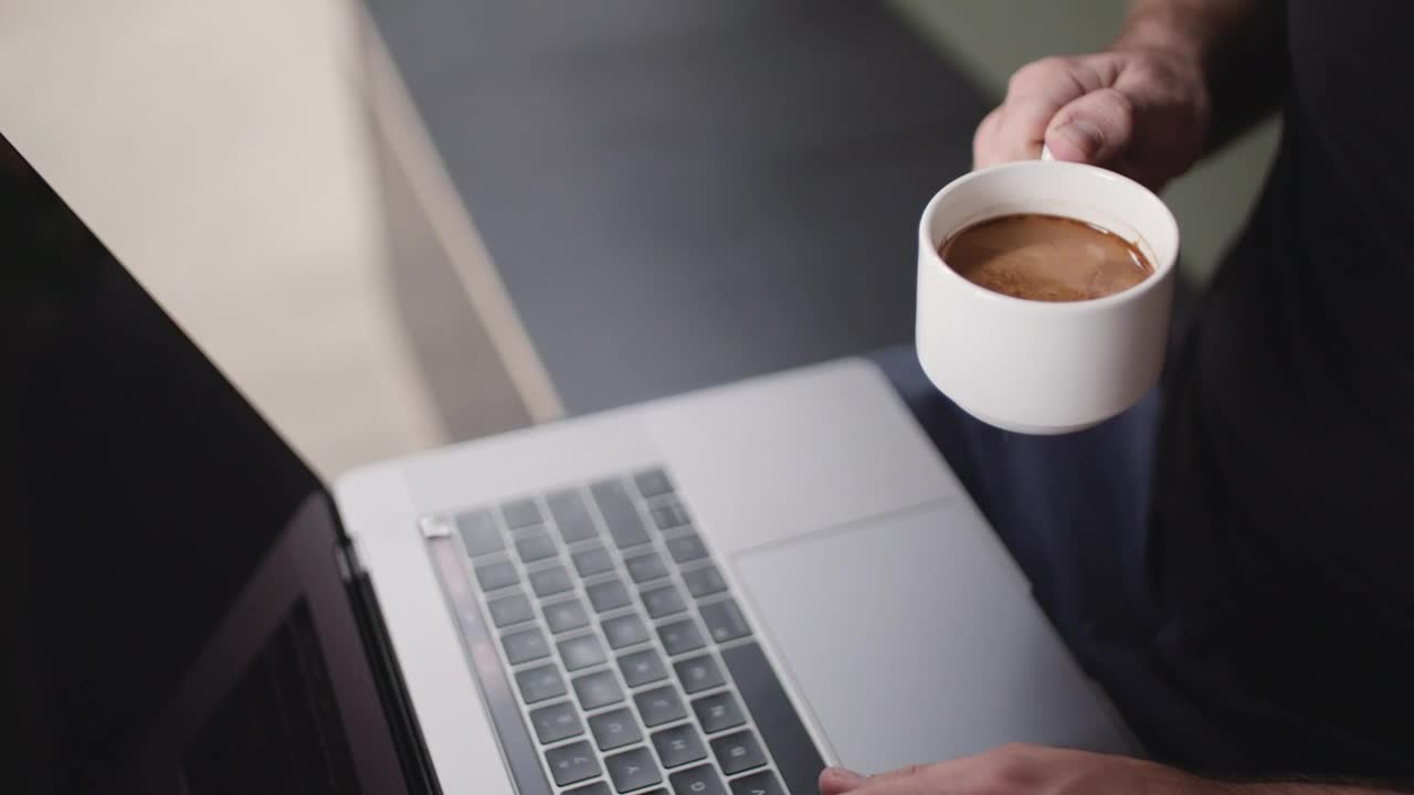 Download Stock Video A Person Drinking Coffee While Using A Laptop Live Wallpaper For PC