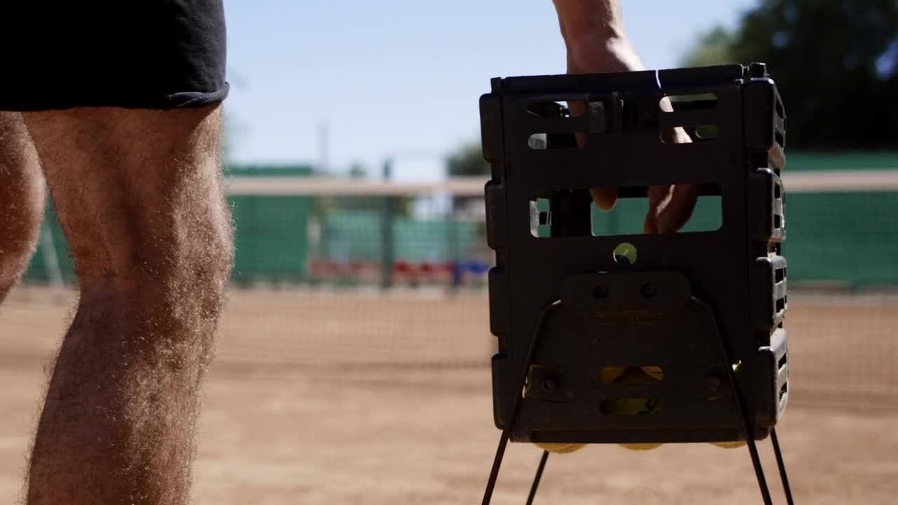 Download Stock Video A Man Takes A Tennis Ball Out Of The Basket Live Wallpaper For PC