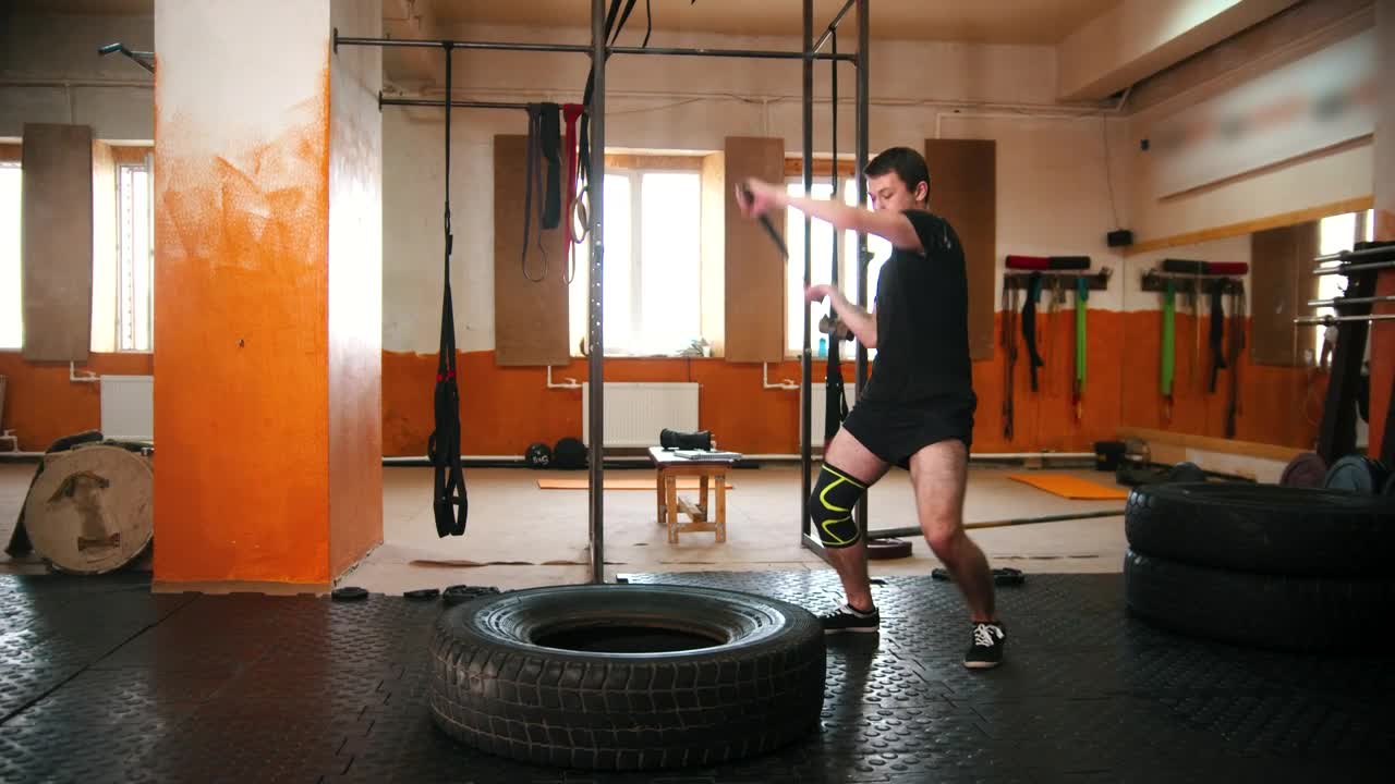 Download Stock Video A Man Hitting A Tire With A Mallet In The Live Wallpaper For PC