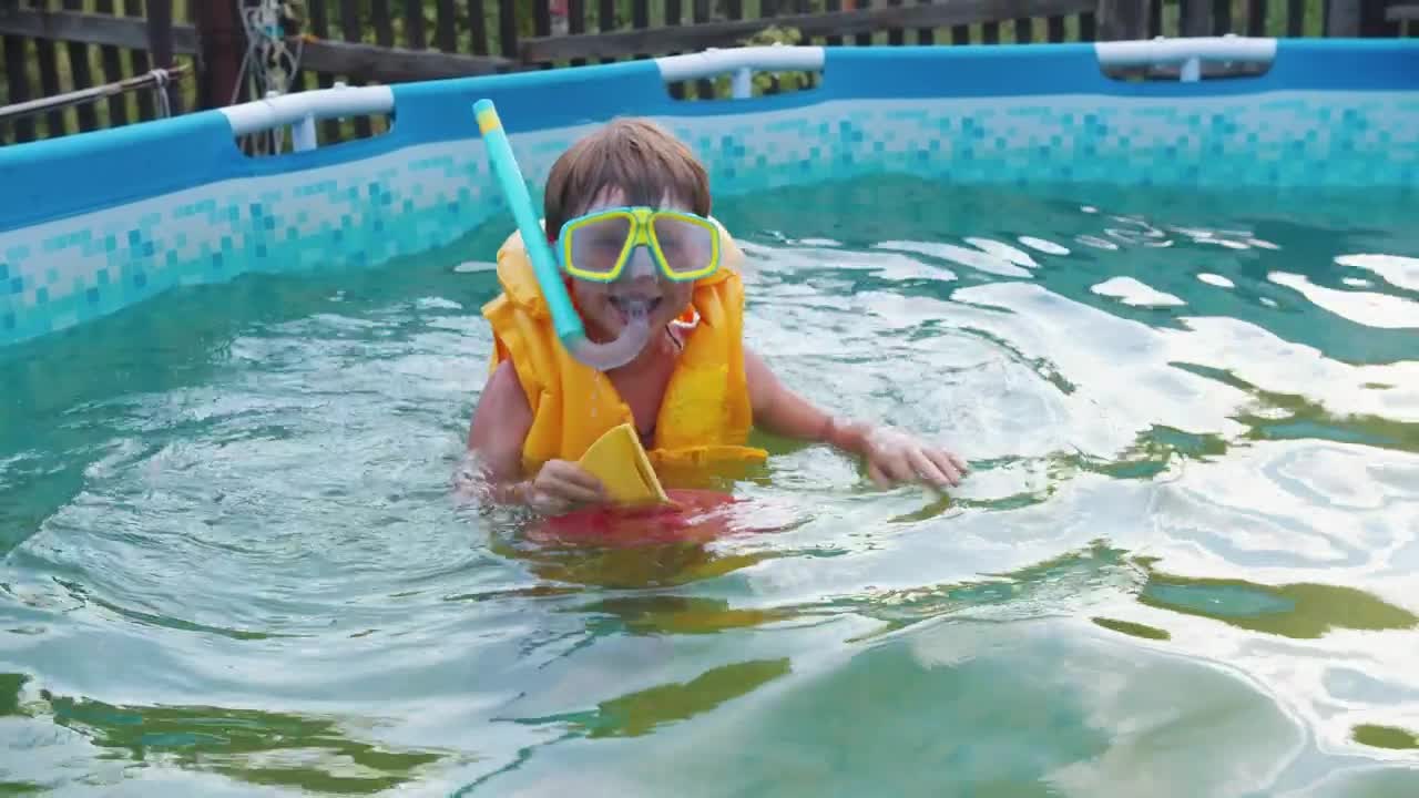 Download Stock Video A Little Boy Swimming In An Inflatable Pool Live Wallpaper For PC