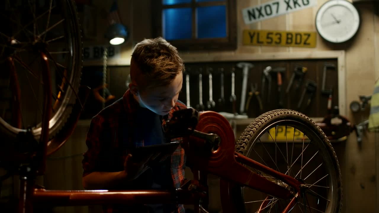 Download Stock Video A Little Boy Is Repairing His Bike With Tutorial Live Wallpaper For PC