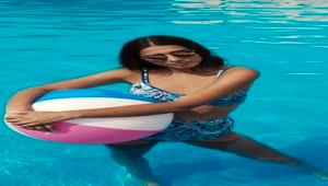 Stock Video A Girl In A Pool Holding An Inflatable Beach Ball Live Wallpaper For PC
