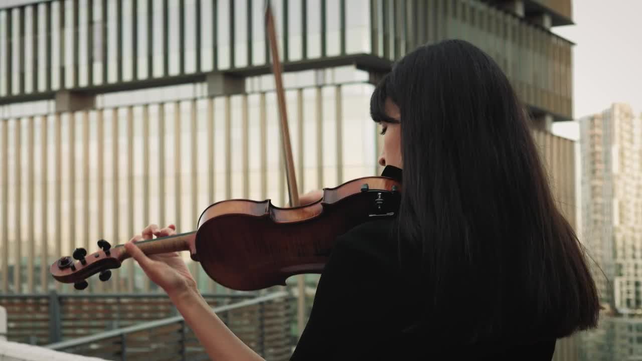 Download Stock Video A Female Violinist Playing Music On A Rooftop Live Wallpaper For PC