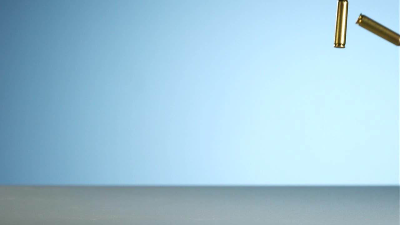 Download Stock Video Bullets Falling And Bouncing On A Blue Background Live Wallpaper For PC