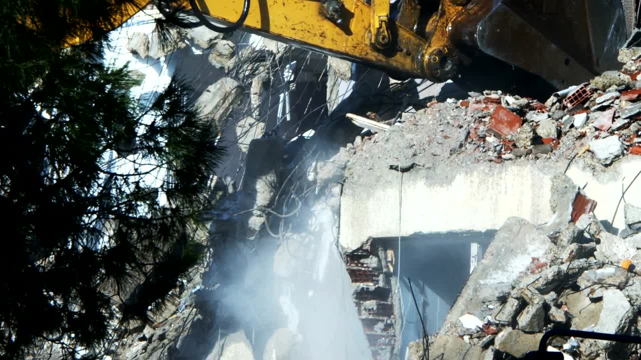 Download Stock Video Bulldozer Cleaning Debris From A Ruined Building Live Wallpaper For PC