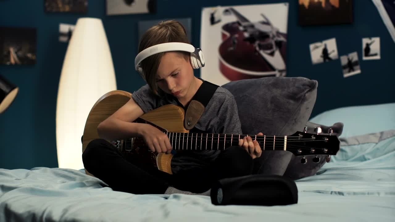 Download Stock Video Boy With Headphones Playing The Guitar In The Room Live Wallpaper For PC