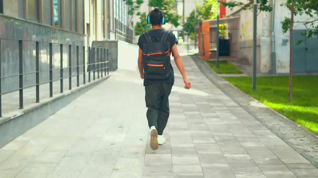 Download Stock Video Boy Walking Happily Down The Street With Headphones Live Wallpaper For PC