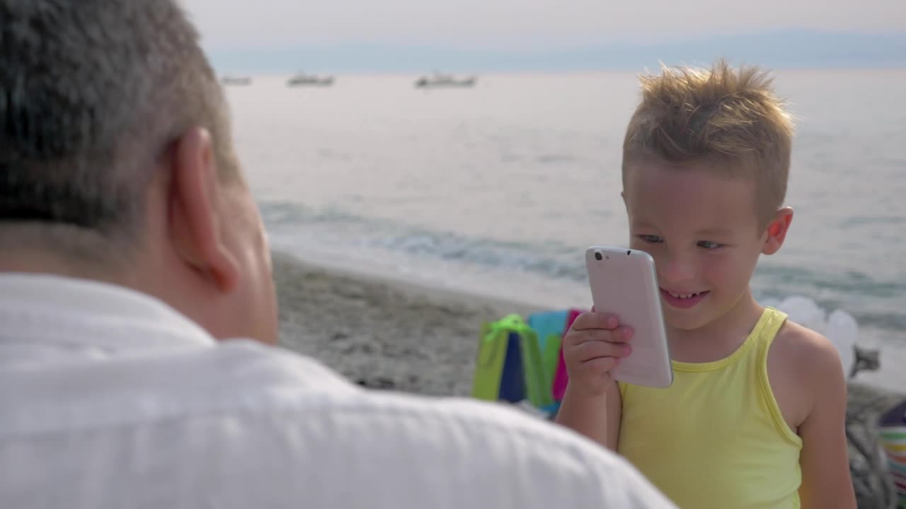 Download Stock Video Boy Taking A Photo On A Phone Live Wallpaper For PC