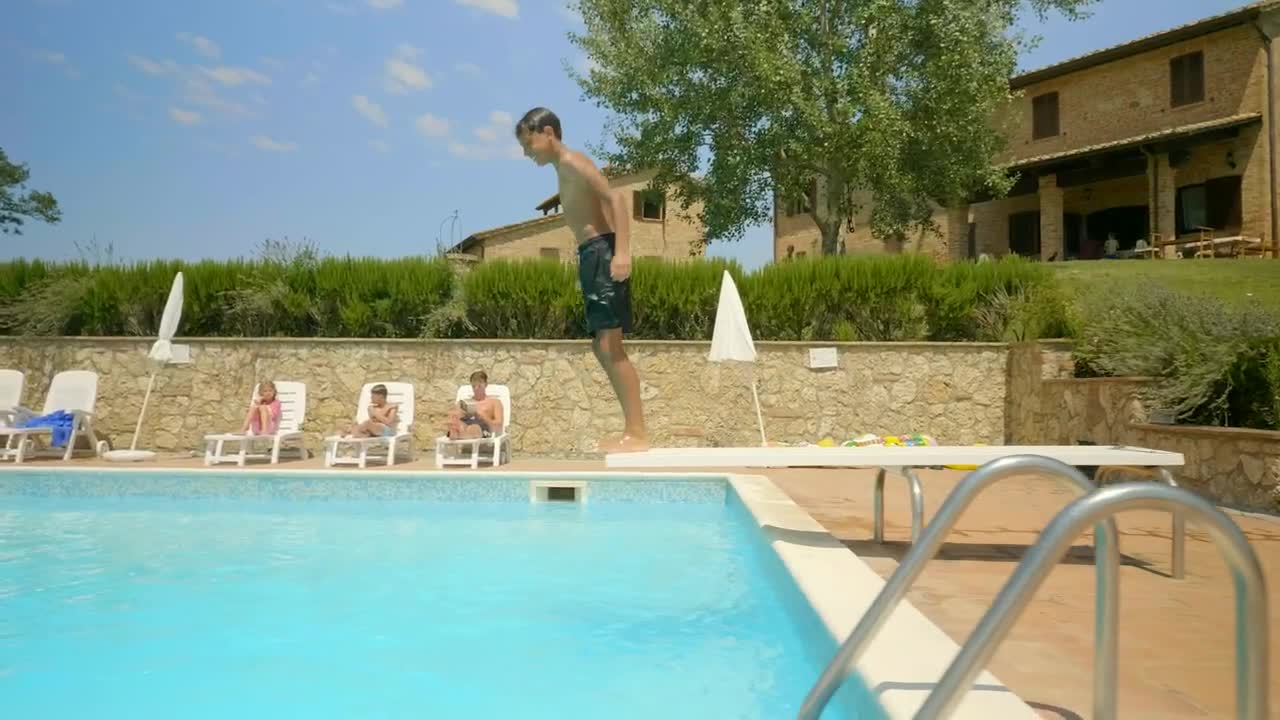 Download Stock Video Boy Swimming In An Outdoor Pool On A Sunny Day Live Wallpaper For PC