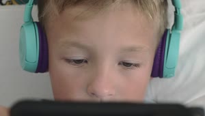 Stock Video Boy Playing Games On A Small Tablet Live Wallpaper For PC