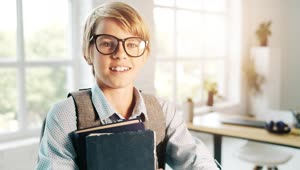 Stock Video Boy In Glasses Smiles And Holds Books In Classroom Live Wallpaper For PC