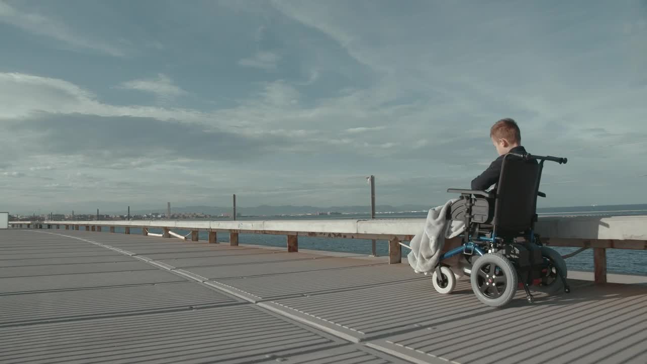Download Stock Video Boy In A Wheelchair Heading Over A Bridge Live Wallpaper For PC