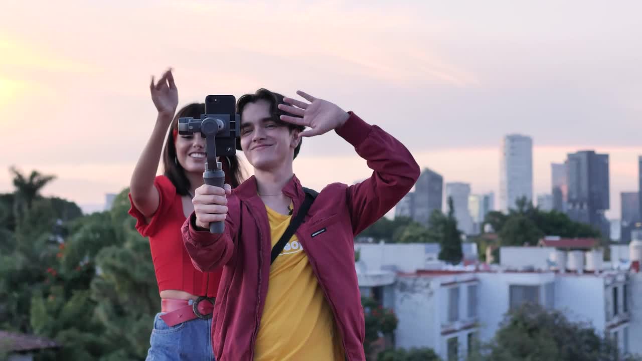 Download Stock Video Boy And Girl Blogging On Top With City Background Live Wallpaper For PC