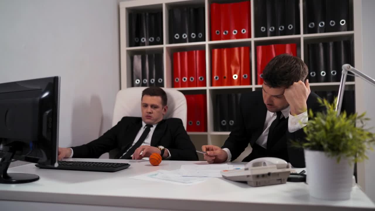 Download Stock Video Bored Young Office Workers In An Office Live Wallpaper For PC