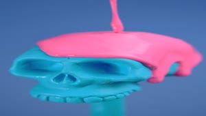 Stock Video Blue Plastic Skull Covered With A Pink Liquid On A Live Wallpaper For PC