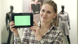 Stock Video Blonde Woman Showing A Tablet With A Green Screen Live Wallpaper For PC