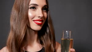 Stock Video Beautiful Woman Smiles And Sips Champagne On Dark Background Live Wallpaper For PC