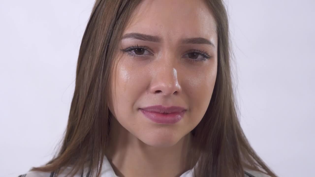 Download Video Stock Closeup Of Young Woman Crying On White Background Live Wallpaper For PC